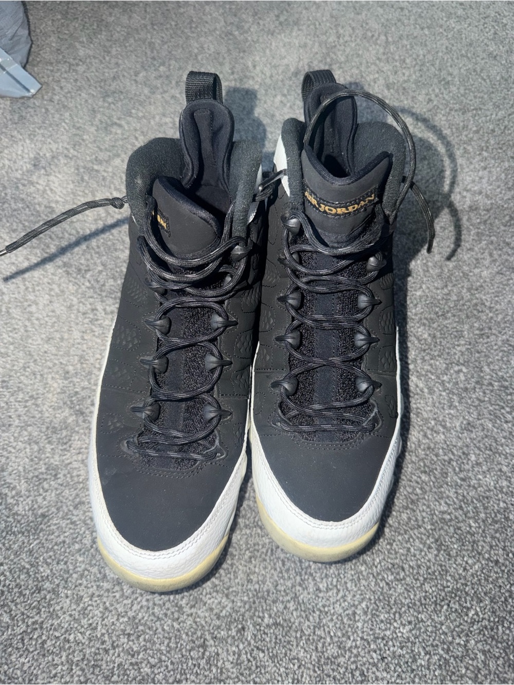 Black and White High-Top Sneakers with Gold Accent. JORDANS